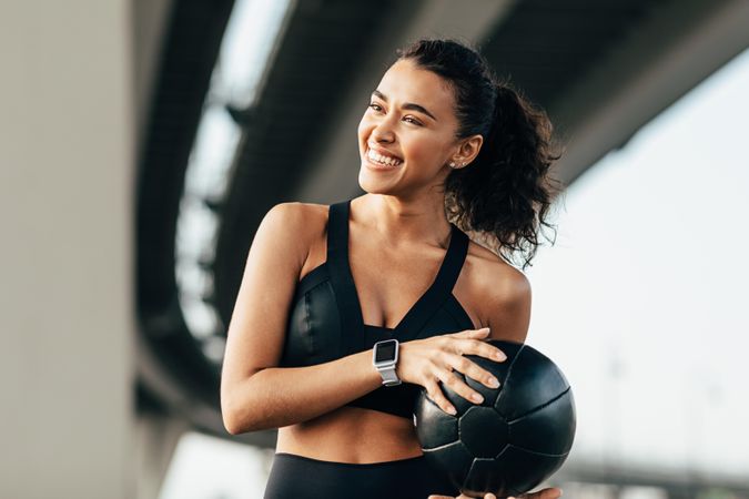 Smiling fit woman with medicine ball