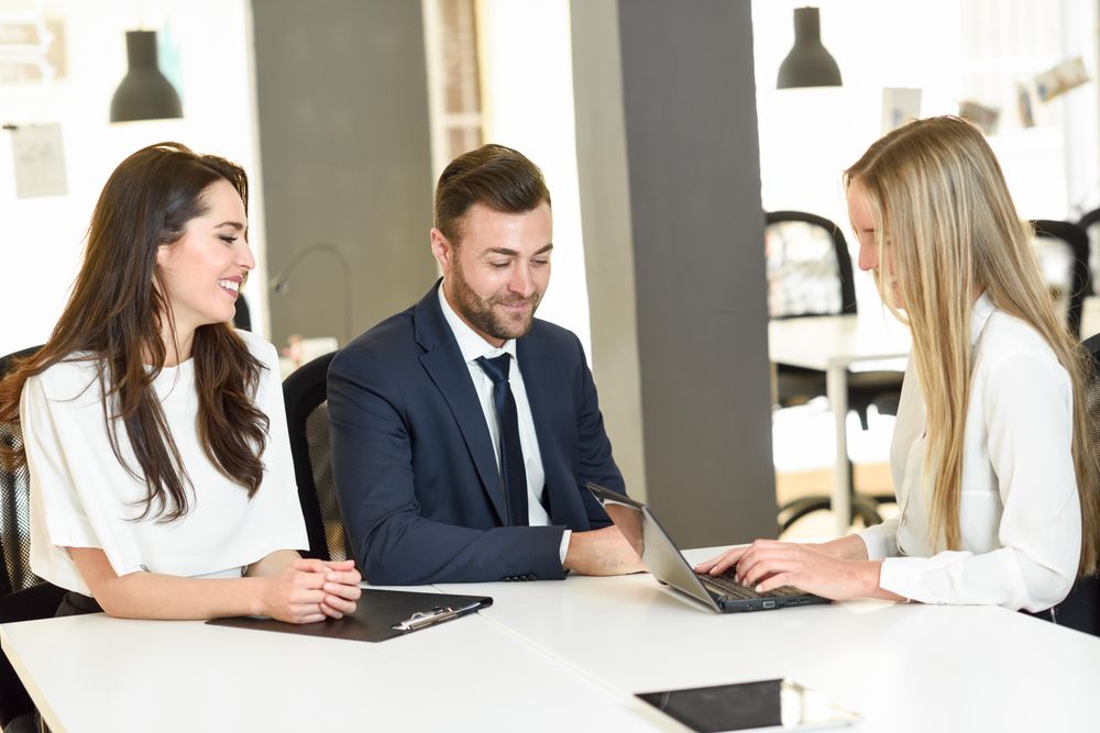Three colleagues working together in modern office