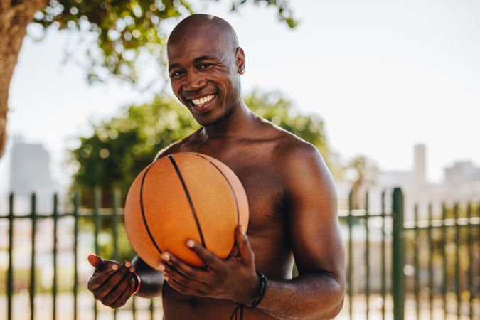 Man smiling with basketball