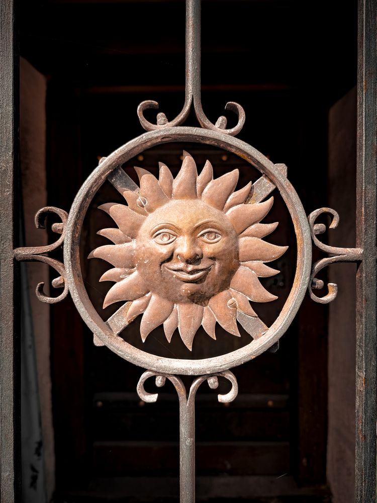 Smiling sun metal door grate