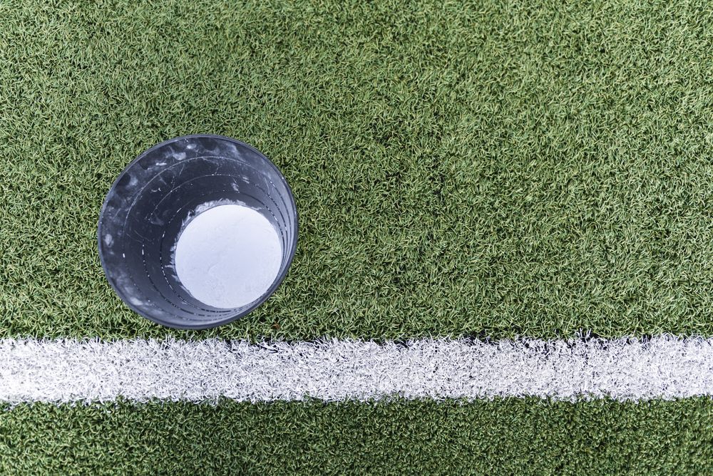 Bucket with chalk on lawn