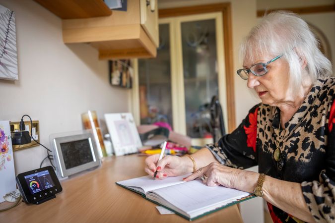 Woman writing at home