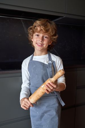 Smiling boy with rolling pin