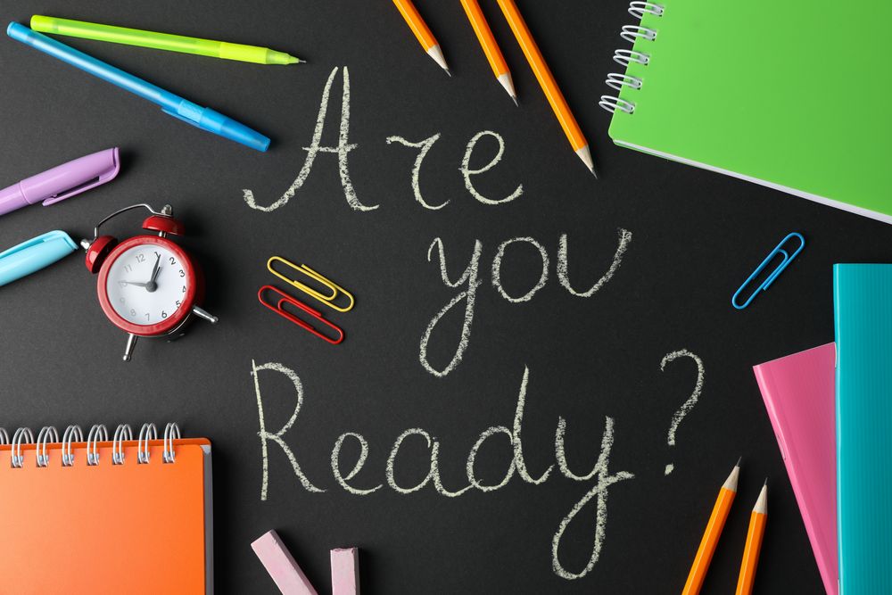 Looking down at chalkboard with the words “are you ready” surrounded by stationary