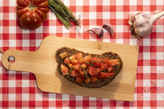 Bruschetta with fresh tomatoes on wooden cutting board