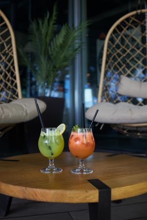 Two colorful cocktails on a wooden table