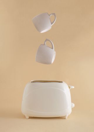 Coffee mugs suspended above a toaster