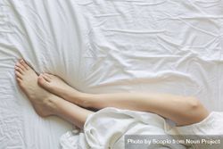 Person lying on bed under blanket 5RBGr5