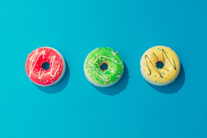 Row of colorful donuts on blue background