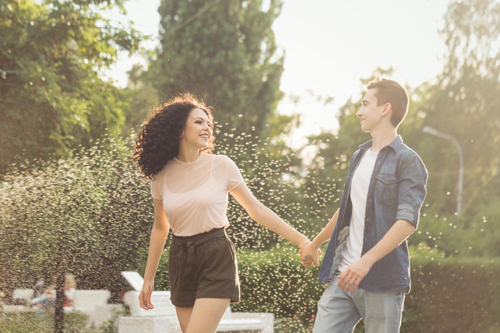 Carefree teenagers are walking in the city park