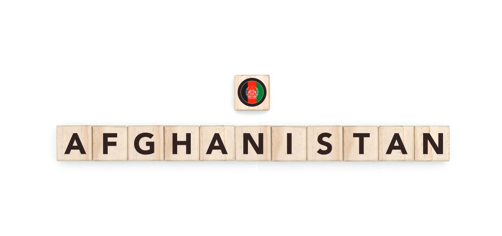 Wooden blocks bearing the name and flag of Afghanistan. Afghan, Arab and Asian Culture, national identity, travel, and geography in a copy space design.
