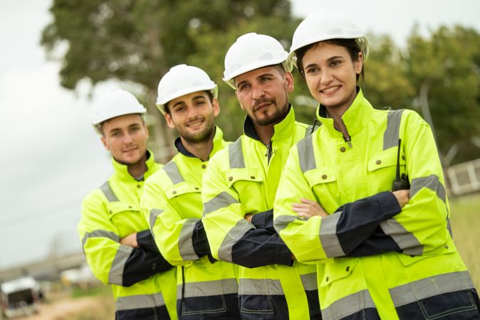 Engineer worker in arms crossed standing in a row looking smile to camera