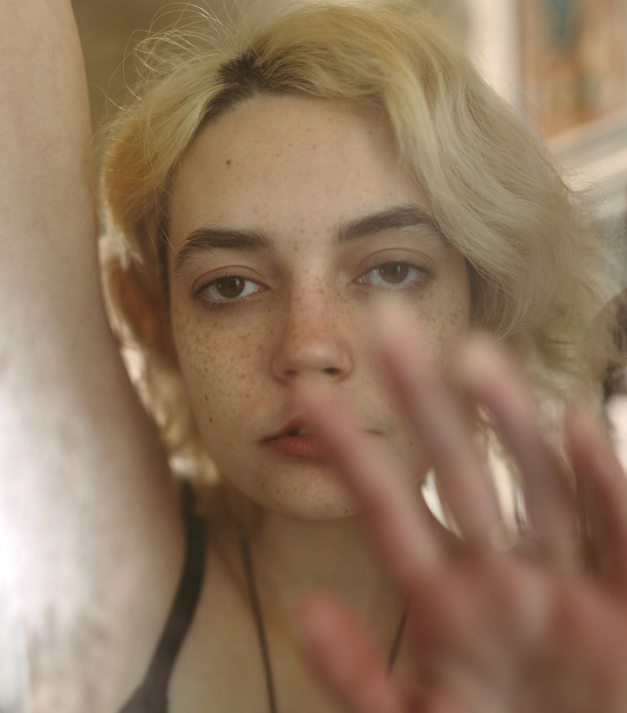 Charming melancholy woman looking at camera