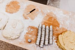 Knife and cups near dough