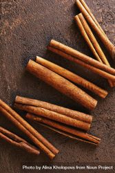 Cinnamon sticks on brown background bYDq14