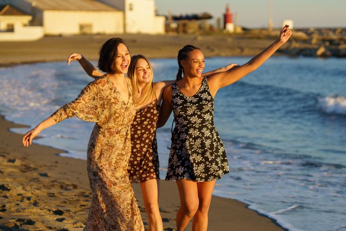 Female friends walking along the shore
