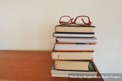 Red framed eyeglasses on books 5rAzP0
