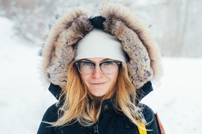 Blonde woman in winter parka on snowy day