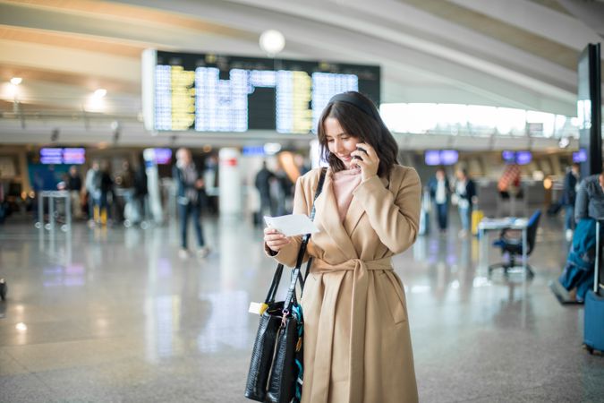 Woman using smartphone at airport
