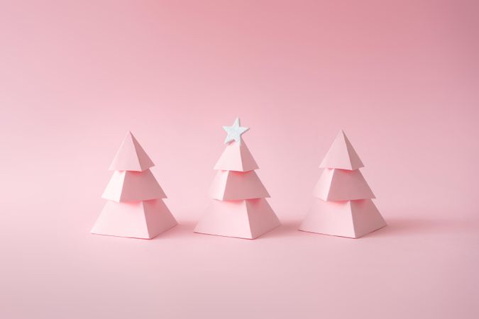 Pink paper Christmas trees on pink background