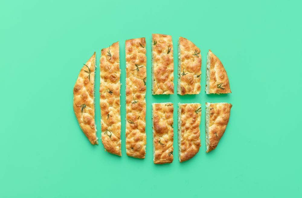 Sliced focaccia on a green background