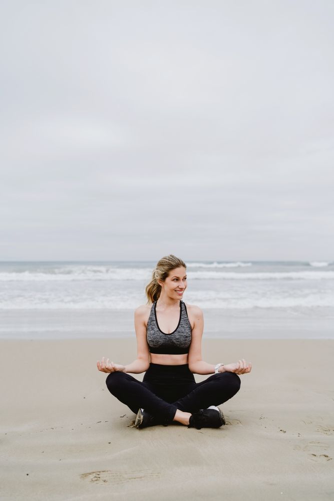 Woman meditating on the beach