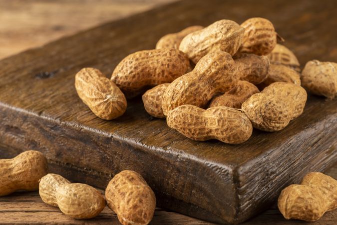 Dry peanut on the wooden background.