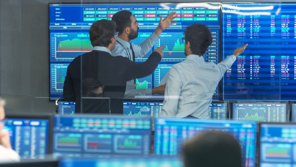 Three Experienced Stock Traders Talking Business, Consulting Documents and Argue About Data.