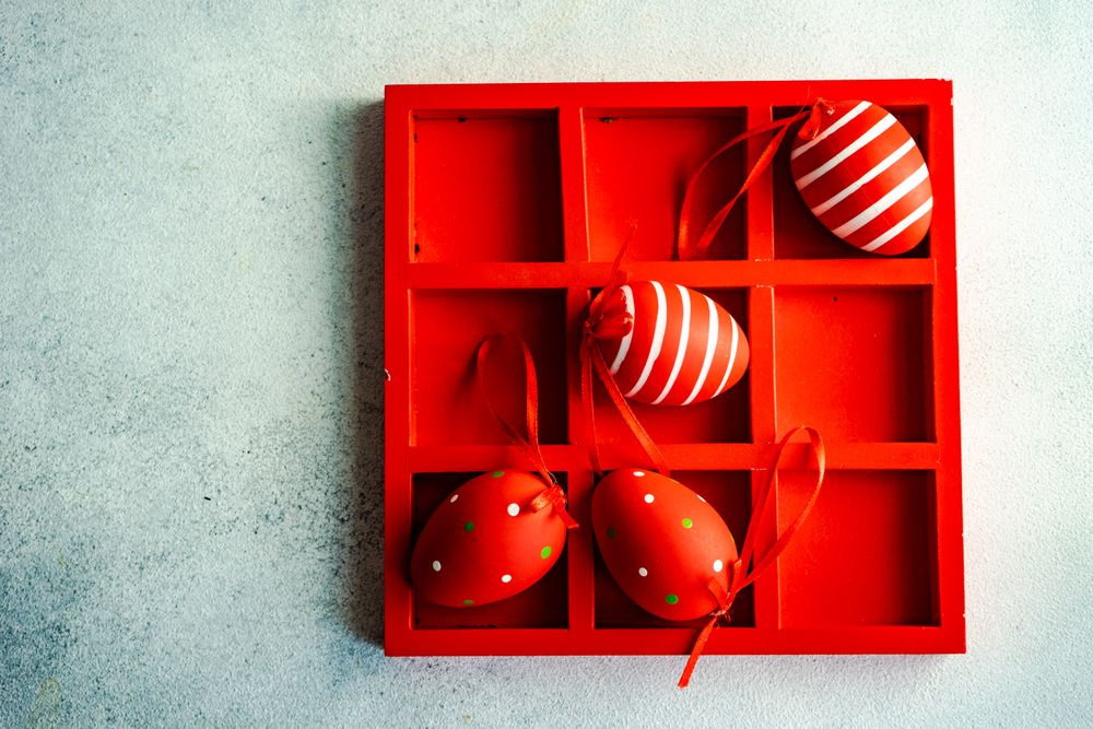 Easter card concept with red box of red decorative eggs