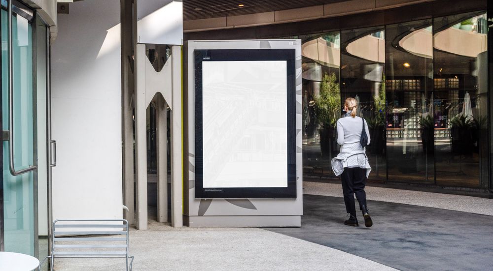 Mockup sign in shopping center with woman walking by