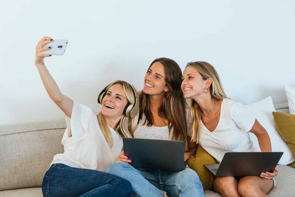 Woman taking a selfie with her sisters