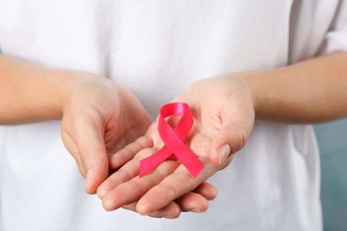 Person in t-shirt hold awareness ribbon, space for text