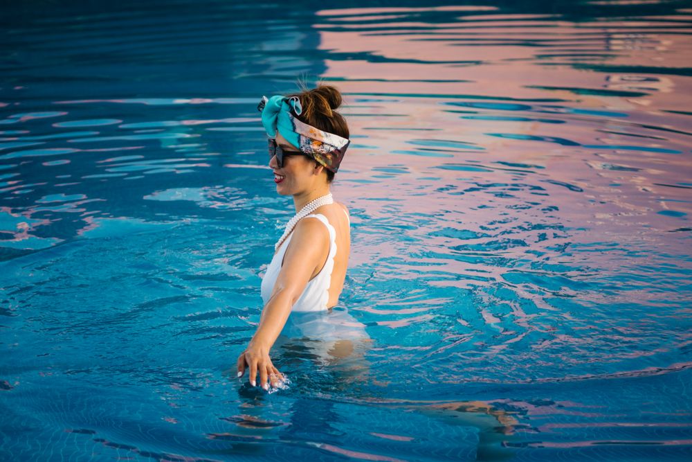 Young elegant Chinese woman relaxing inside a pool