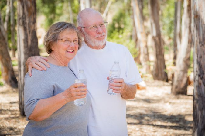 Happy Healthy Mature Couple with Water Bottles