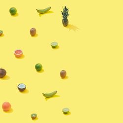 Tropical fruit pattern on pastel yellow backround