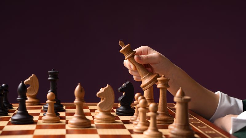 Hand with chess piece