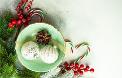 Top view of bauble ornament in green wintry plate with candy cane