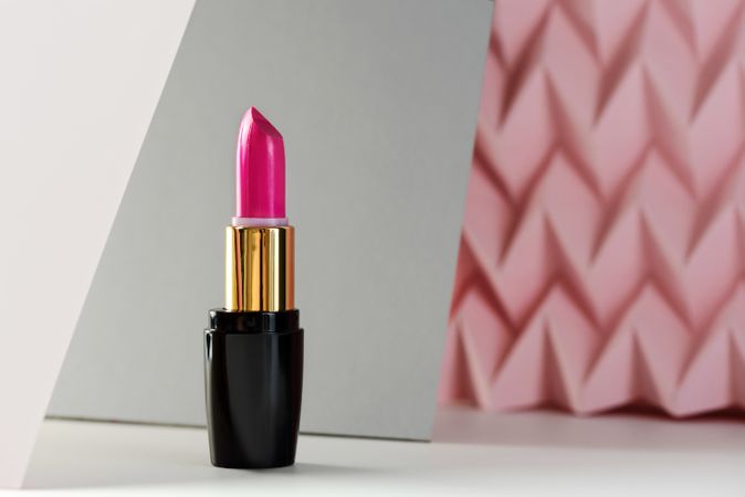 Lipstick on raised pink chevron. Product and make up concept