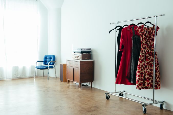 Clothing rack with vintage dresses in a bright loft space
