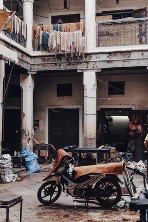 Old motorbike in shabby courtyard