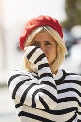 female in red beret outdoors