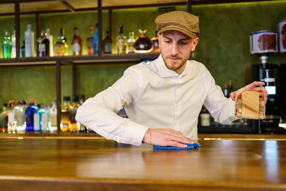 Bartender cleaning bar