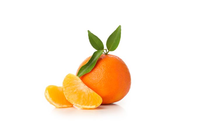 Ripe mandarin with leaves isolated on light background