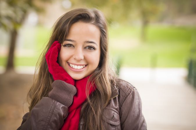 Portrait of Woman Wearing Red Scarf and Mittens Outside