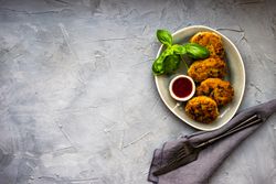 Top view of pork cutlets served with fresh basil