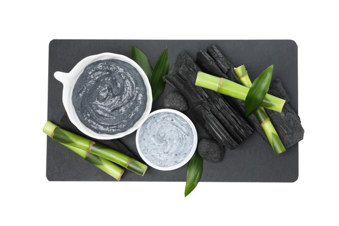 Fresh bamboo shoots with charcoal in the form of a paste, isolated on plain background