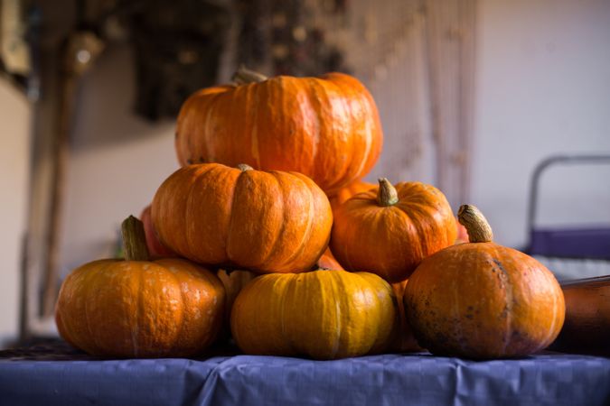 Pile of fresh ripe orange pumpkins on table
