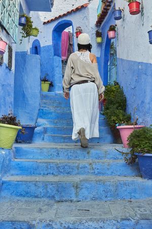 Woman on steps between ancient buildings