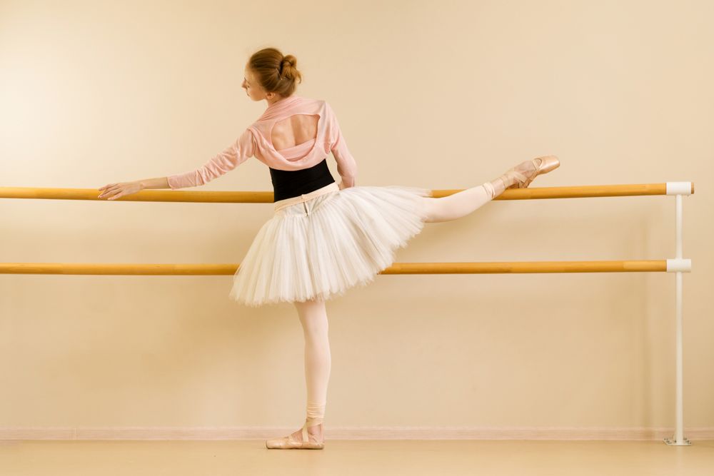 Ballet dancer practicing leg stretch
