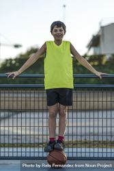 Portrait of a young teen wearing a yellow basketball sleeveless smiling 4B1LW5